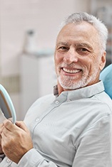 dental patient holding a hand mirror 