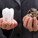 Hands holding molar and coins