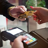 Man handing woman credit card