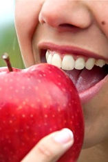 close up person about to eat apple