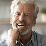 older man smiling with dentures 