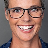 woman with glasses smiling 