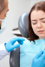 woman with toothache talking to her emergency dentist in Park Slope