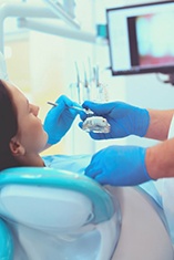 Dentist treats patient