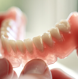 person holding a partial denture