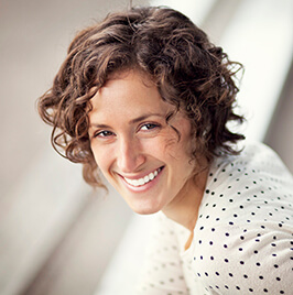 woman in polka dots top, smiling