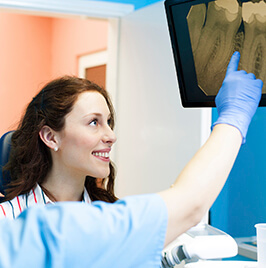 dentist showing dental x-ray to patient