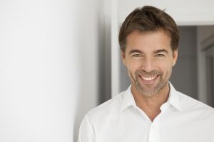 man in white shirt smiling