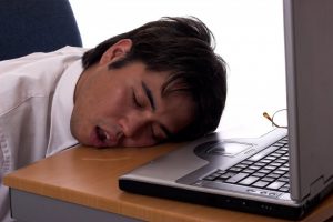 man asleep drooling on desk