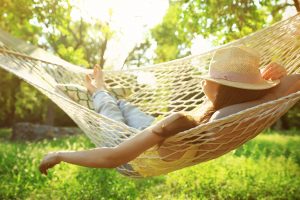 woman relaxing in hammock after Slope park dentist tooth extraction