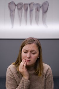 Woman in pain at emergency dentist in Park Slope.