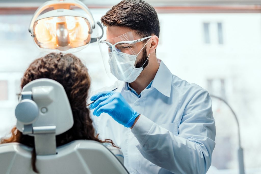patient receiving dentures from dentist