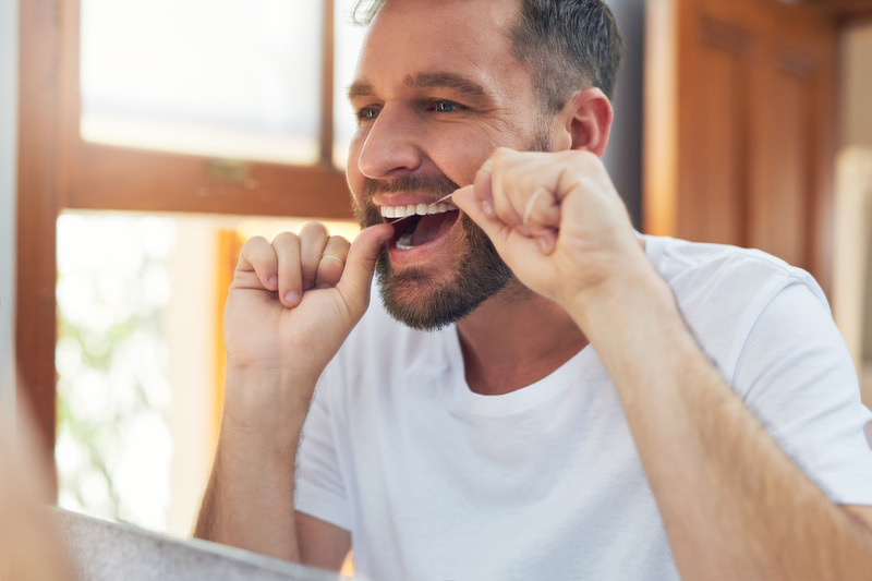 Patient with good oral health flossing